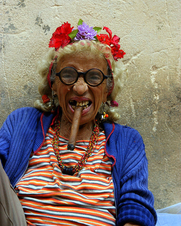 Woman smoking cigar in Cuba